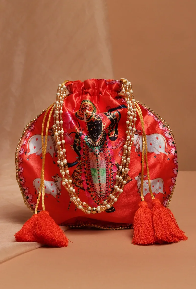 Shreenath’s Radiant Orange Potli With White Moti